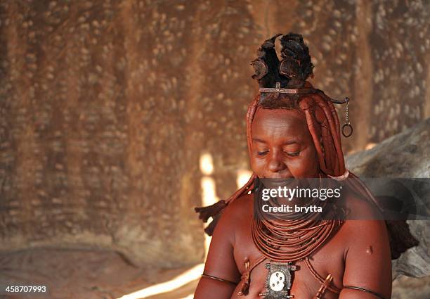 married himba woman inside hut in village near opuwo,namibia - himba stockfoto's en -beelden