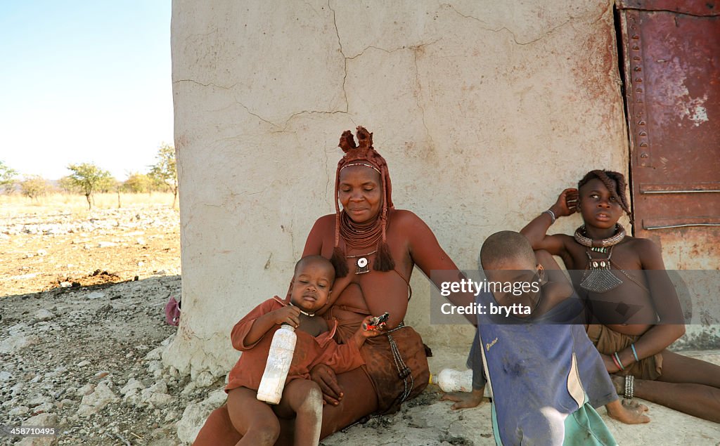 Himba mother  with children in village near Opuwo,Kaokoveld,Namibia