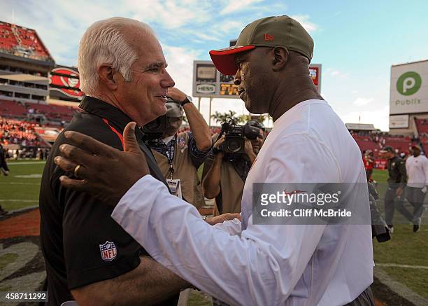 Head coach Mike Smith of the Atlanta Falcons and head coach Lovie Smith of the Tampa Bay Buccaneers shake hands after the game at Raymond James...