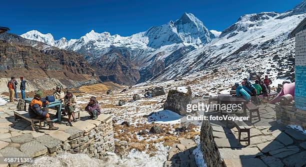 sherpas and porters relaxing at annapurna base camp himalayas nepal - base camp stock pictures, royalty-free photos & images