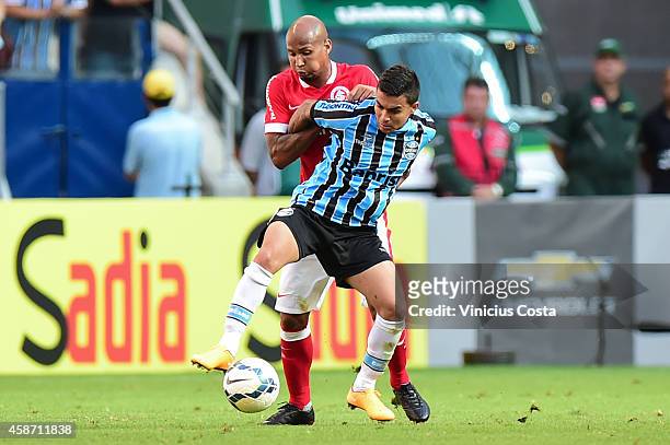 Dudu of Gremio battles for the ball against Wellinton Silva of Internacional during match between Gremio and Internacional as part of Brasileirao...