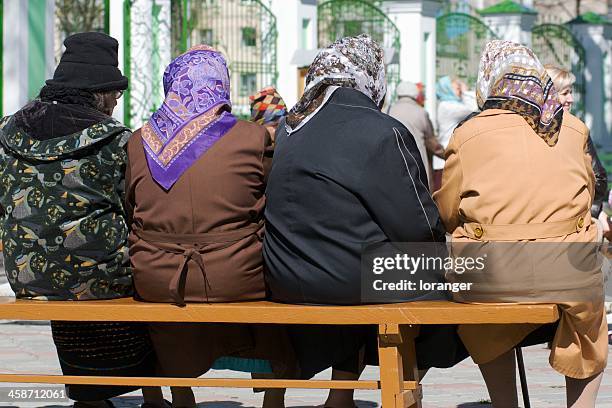 elderly women sitting on a bench - babushka stock pictures, royalty-free photos & images
