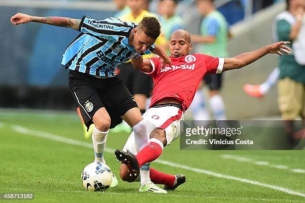 Luan of Gremio battles for the ball against Wellinton Silva of Internacional during match between Gremio and Internacional as part of Brasileirao...