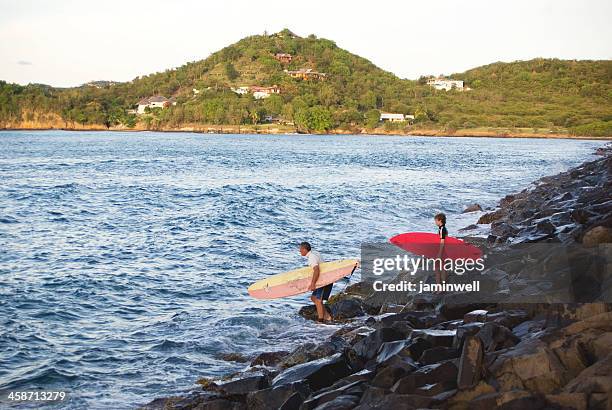 father and son going surfing - gros islet stock pictures, royalty-free photos & images