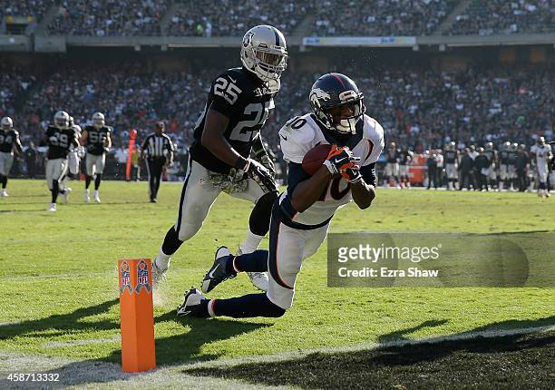 Emmanuel Sanders of the Denver Broncos scores a touchdown at the end of the first half against the Oakland Raiders at O.co Coliseum on November 9,...