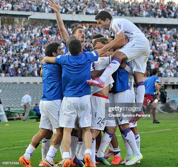 Sebastian Fernandez of Nacional and his teammates celebrate after scoring the opening goal during a match between Nacional and Peñarol as part of...