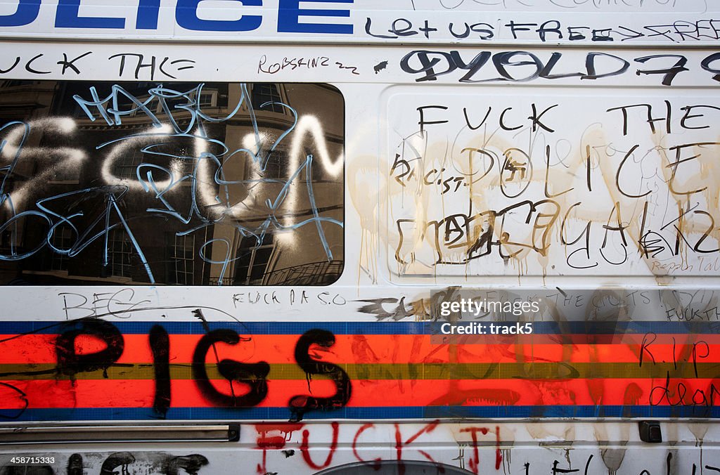 Vandalised police van, London.