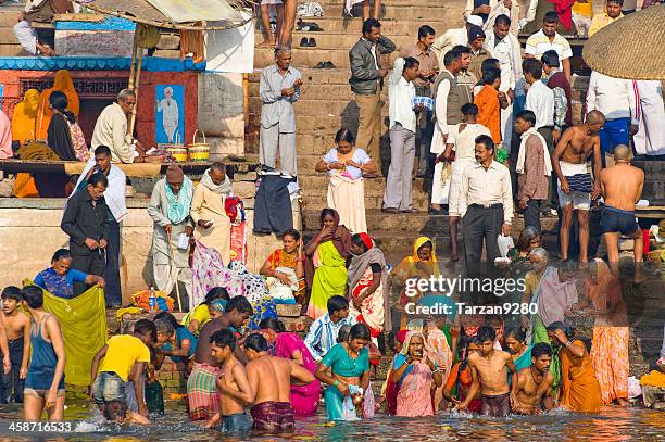 pilgrims bathing in the holy ganges river, varanasi, india - pilgrim stock pictures, royalty-free photos & images