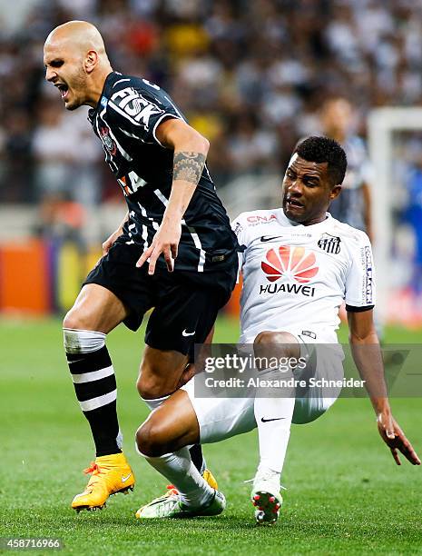 Fabio Santos of Corinthians and Cicinho of Santos in action during the match between Corinthians and Santos for the Brazilian Series A 2014 at Arena...