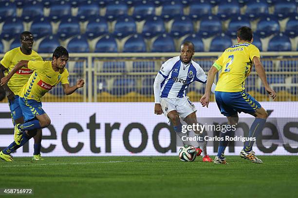 Porto's midfielder Yacine Brahimi tries to escape Estoril defenders during the Portuguese First League match between GD Estoril Praia and FC Porto at...