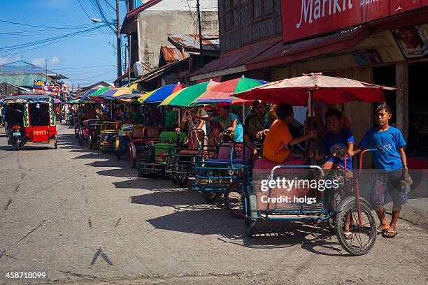 davao, philippines row of &quot;pedicabs&quot; or local rickshaws - davao city stock pictures, royalty-free photos & images