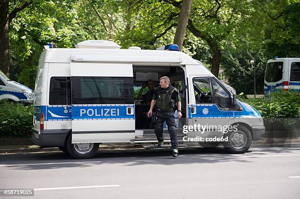 german police officer exitin squad car during frankfurt blockupy prostests - germany police stock pictures, royalty-free photos & images