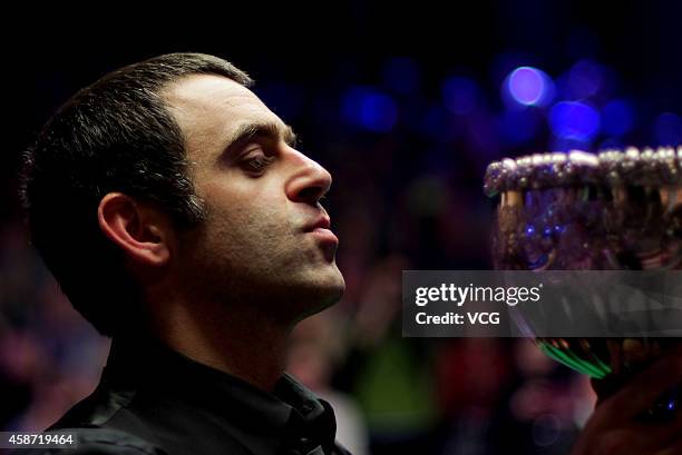 Ronnie O'Sullivan of England celebrates with his trophy after winning the final match against Judd Trump of England on day six of the 2014 Dafabet...