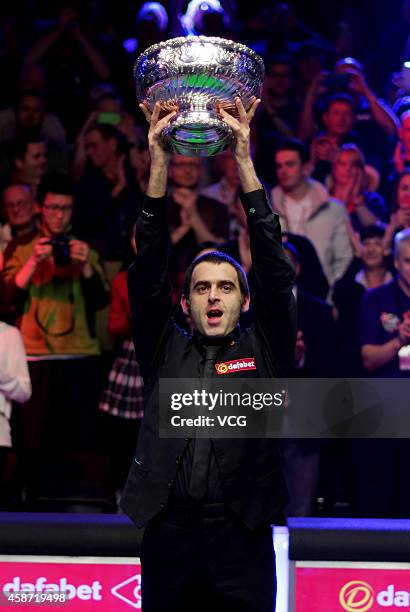 Ronnie O'Sullivan of England celebrates with his trophy after winning the final match against Judd Trump of England on day six of the 2014 Dafabet...