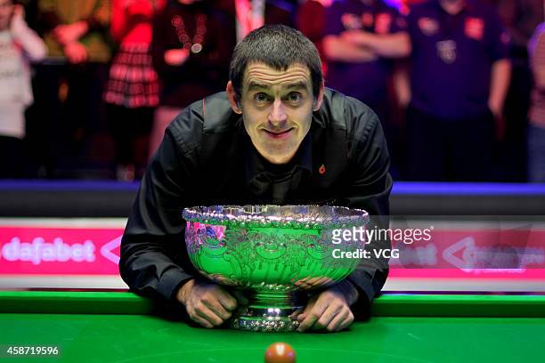 Ronnie O'Sullivan of England celebrates with his trophy after winning the final match against Judd Trump of England on day six of the 2014 Dafabet...