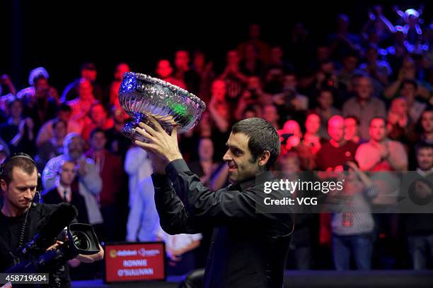 Ronnie O'Sullivan of England celebrates with his trophy after winning the final match against Judd Trump of England on day six of the 2014 Dafabet...