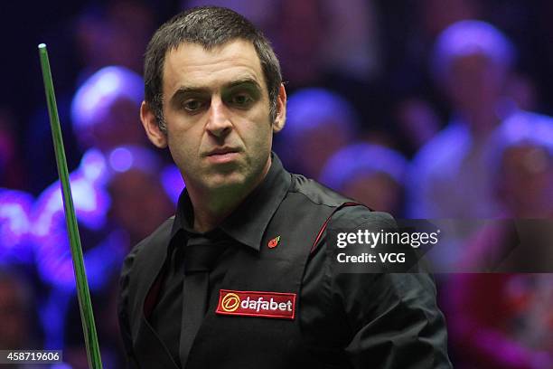 Ronnie O'Sullivan of England reacts against Judd Trump of England during their final match on day six of the 2014 Dafabet Champion of Champions at...