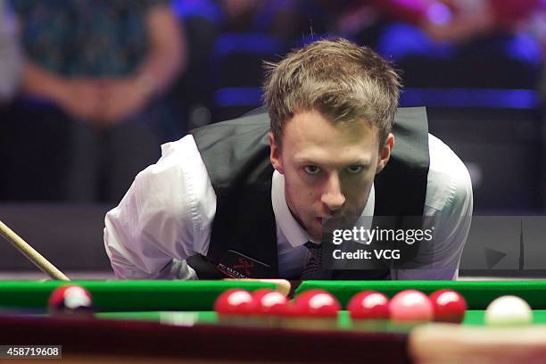 Judd Trump of England eyes the ball against Ronnie O'Sullivan of England during their final match on day six of the 2014 Dafabet Champion of...