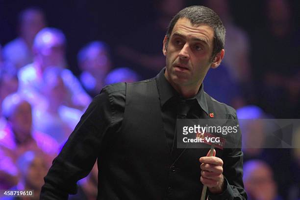 Ronnie O'Sullivan of England reacts against Judd Trump of England during their final match on day six of the 2014 Dafabet Champion of Champions at...