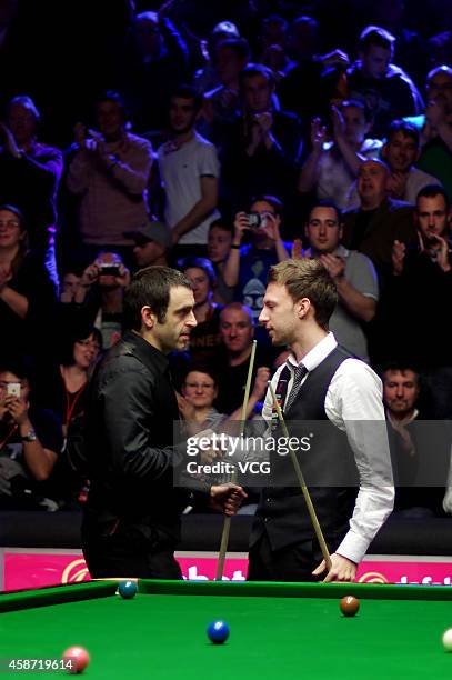 Ronnie O'Sullivan of England shakes hands with Judd Trump of England after their final match on day six of the 2014 Dafabet Champion of Champions at...