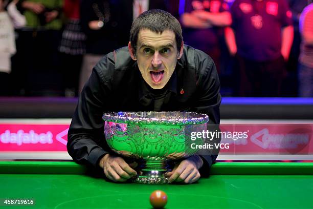 Ronnie O'Sullivan of England celebrates with his trophy after winning the final match against Judd Trump of England on day six of the 2014 Dafabet...