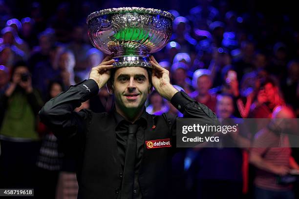 Ronnie O'Sullivan of England celebrates with his trophy after winning the final match against Judd Trump of England on day six of the 2014 Dafabet...