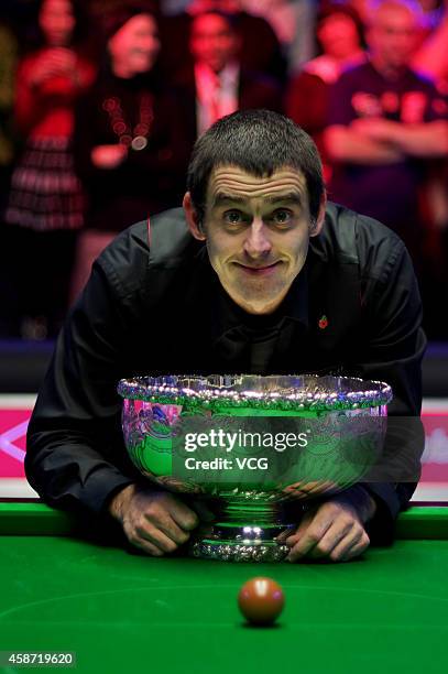 Ronnie O'Sullivan of England celebrates with his trophy after winning the final match against Judd Trump of England on day six of the 2014 Dafabet...