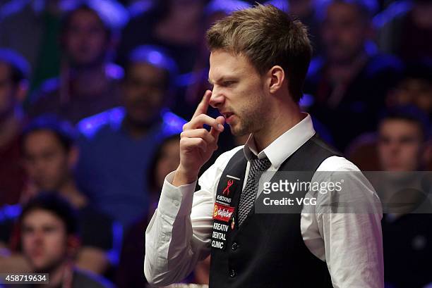 Judd Trump of England reacts against Ronnie O'Sullivan of England during their final match on day six of the 2014 Dafabet Champion of Champions at...