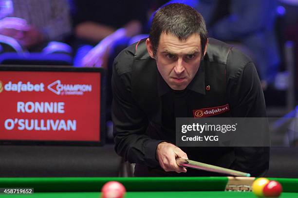 Ronnie O'Sullivan of England eyes the ball against Judd Trump of England during their final match on day six of the 2014 Dafabet Champion of...