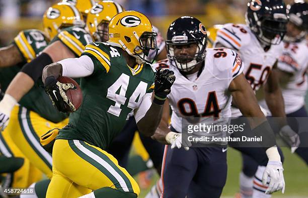 James Starks of the Green Bay Packers carries the football past Cornelius Washington of the Chicago Bears at Lambeau Field on November 9, 2014 in...