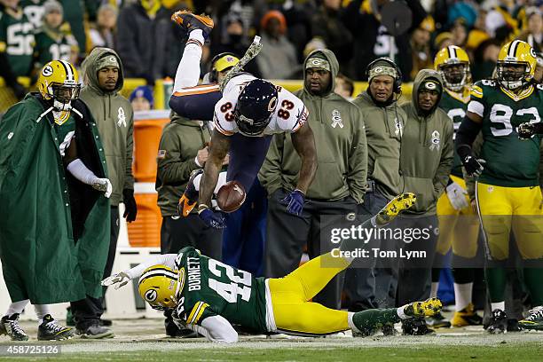 Morgan Burnett of the Green Bay Packers hits Martellus Bennett of the Chicago Bears in the second quarter during the NFL game at Lambeau Field on...