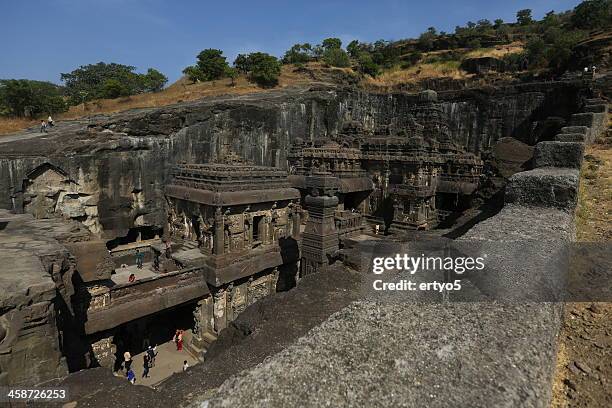 tourists enjoy carvings at the ellora caves - ellora stock pictures, royalty-free photos & images