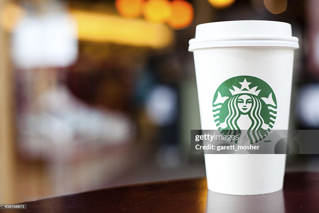 Grande Starbucks to go cup on table