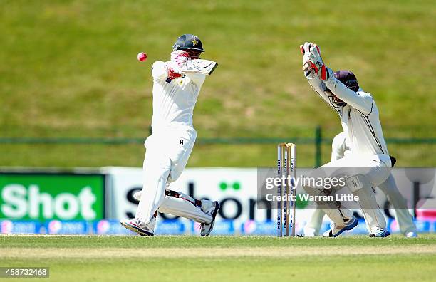 Ahmed Shehzad of Pakistan is hit on the head and tumlbes into his wicket from the bowling of Corey Anderson of New Zealand during day two of the...