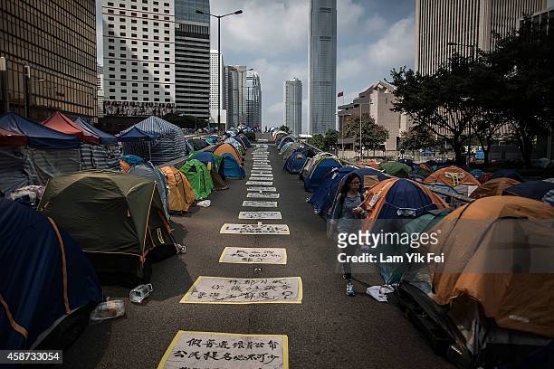 Woman walks past tents at Admiralty occupy site on November 10, 2014 in Hong Kong. The occupy movement which began in Hong Kong on September 28, 2014...