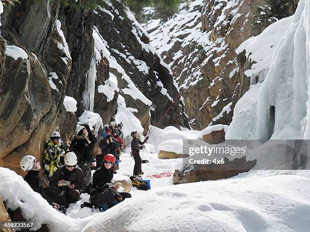 ice climbing group activity - rock climber stockfoto's en -beelden