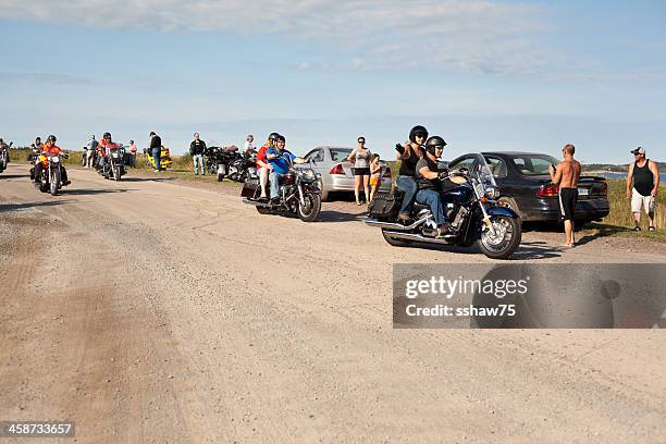 passsenger on motorcycle waving - harley davidson woman stock pictures, royalty-free photos & images