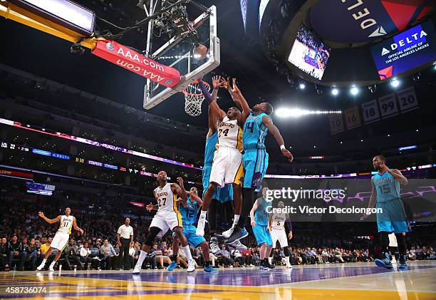 Kobe Bryant of the Los Angeles Lakers tries for a layup against Michael Kidd-Gilchrist of the Charlotte Hornets in the second half during the NBA...