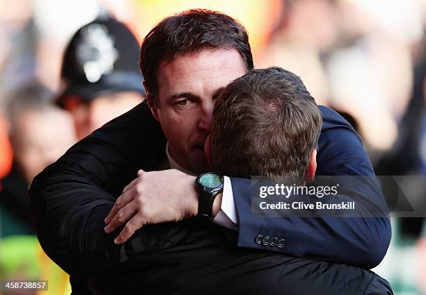 Cardiff City manager Malky Mackay is embraced by Liverpool manager Brendan Rogers before the Barclays Premier League match between Liverpool and...