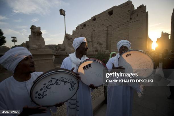 An Egyptian Nubian band performs traditional songs as they celebrate the aligned of the winter solstice sunrise to the Temple of Karnak, in the...