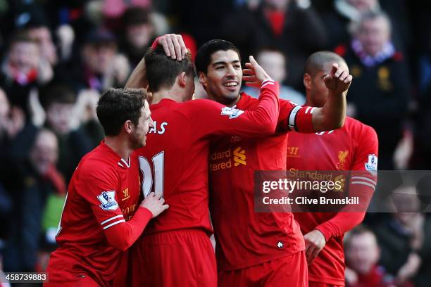 Luis Suarez of Liverpool celebrates with team mates after scoring during the Barclays Premier League match between Liverpool and Cardiff City at...