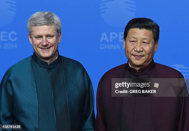 Canada's Prime Minister Stephen Harper poses with Chinese President Xi Jinping upon arrival for Asia-Pacific Economic Cooperation Summit banquet at...