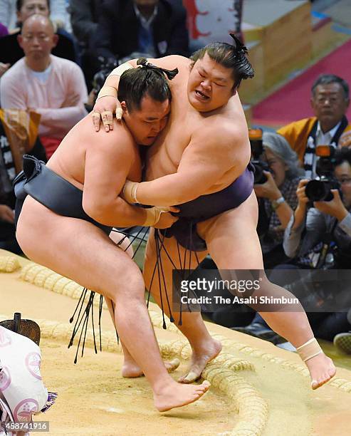 Mongolian yokozuna Kakuryu pushes Takekaze out from the ring to win during day one of the Grand Sumo Kyushu Tournament at Fukuoka Convention Center...