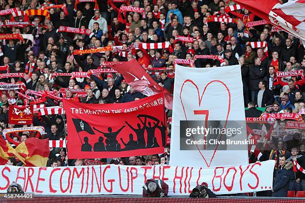 Liverpool fans with a number seven banner after Luis Suarez signs a new contract with the club prior to the Barclays Premier League match between...