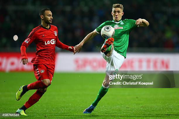 Oemer Toprak of Leverkusen challenges Nils Petersen of Bremen during the Bundesliga match between Werder Bremen and Bayer Leverkusen at Weserstadion...