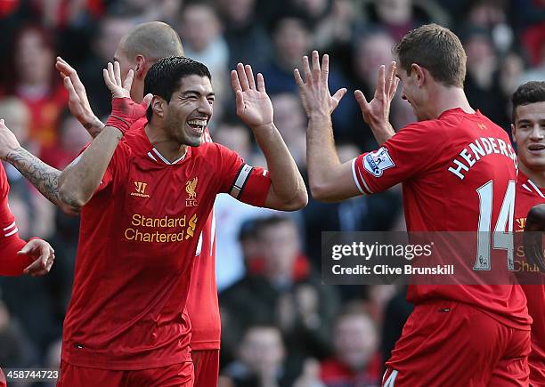 Luis Suarez of Liverpool celebrates after scoring his second goal with team mate Jordan Henderson during the Barclays Premier League match between...