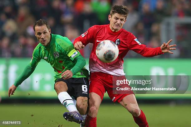 Vaclav Pilar of Freiburg battles for the ball with Steven Cherundolo of Hannover during the Bundesliga match between SC Freiburg and Hannover 96 at...