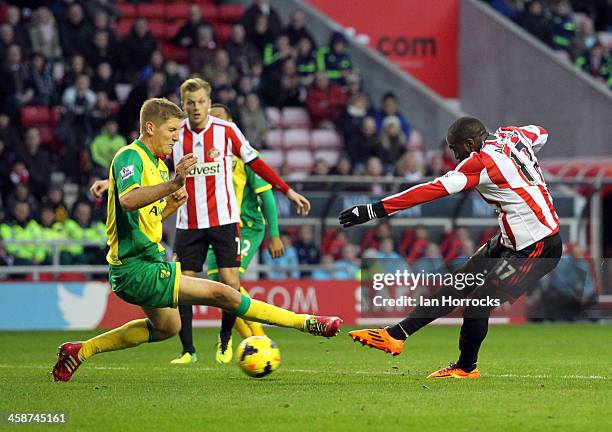 Jozy Altidore of Sunderland shoots on goal with Michael Turner of Norwich City trying to block the shot during the Barclays Premier League match...