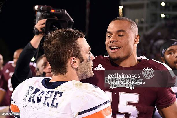 Dak Prescott of the Mississippi State Bulldogs greets Dylan Favre of the Tennessee Martin Skyhawks following a game at Davis Wade Stadium on November...