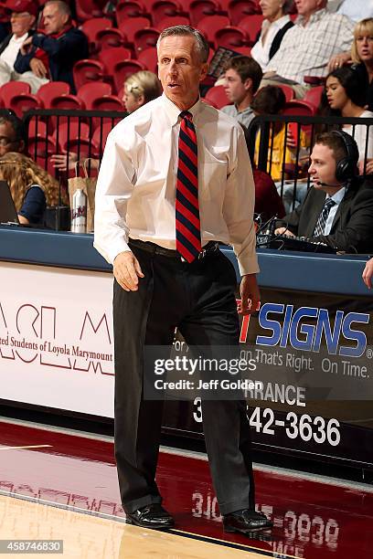 First year head coach Mike Dunlap of the Loyola Marymount Lions looks on as he walks toward the bench against the UC San Diego Tritons during the...